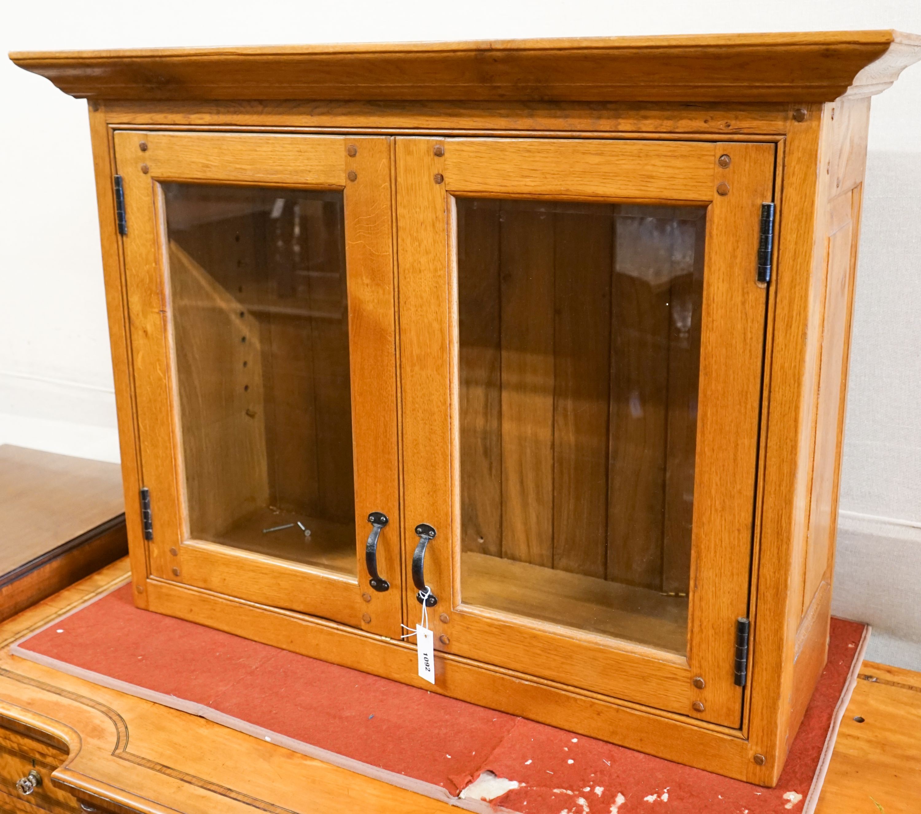 A glazed oak two door wall cabinet, width 107cm, depth 37cm, height 80cm